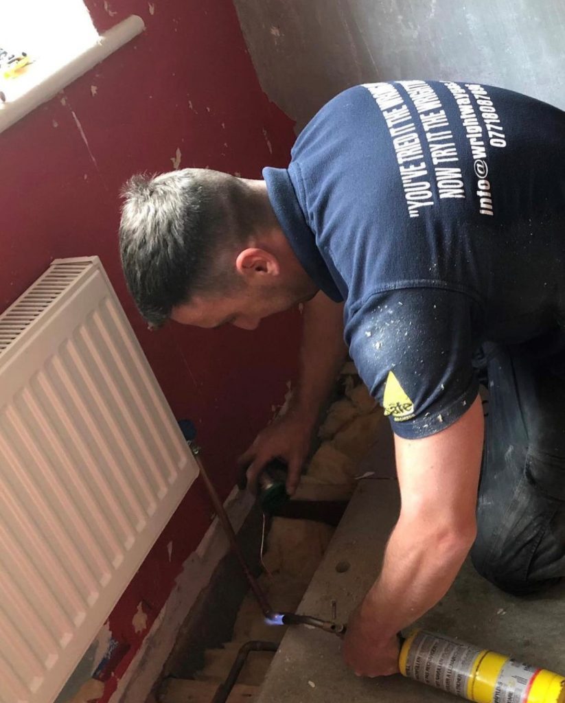 Mason Wright Gas Engineer repairing a radiator