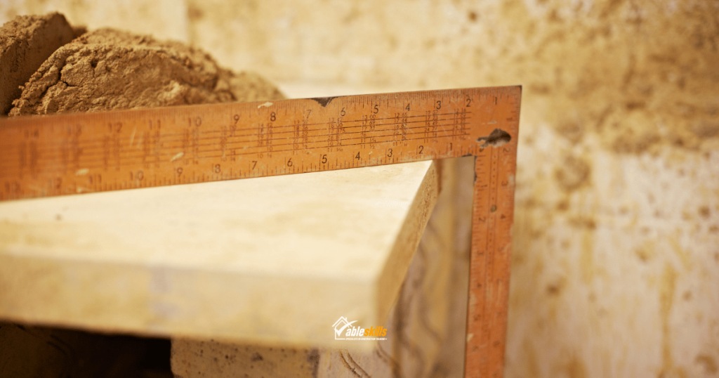 Right-angel rule with sand or cement on a block wall